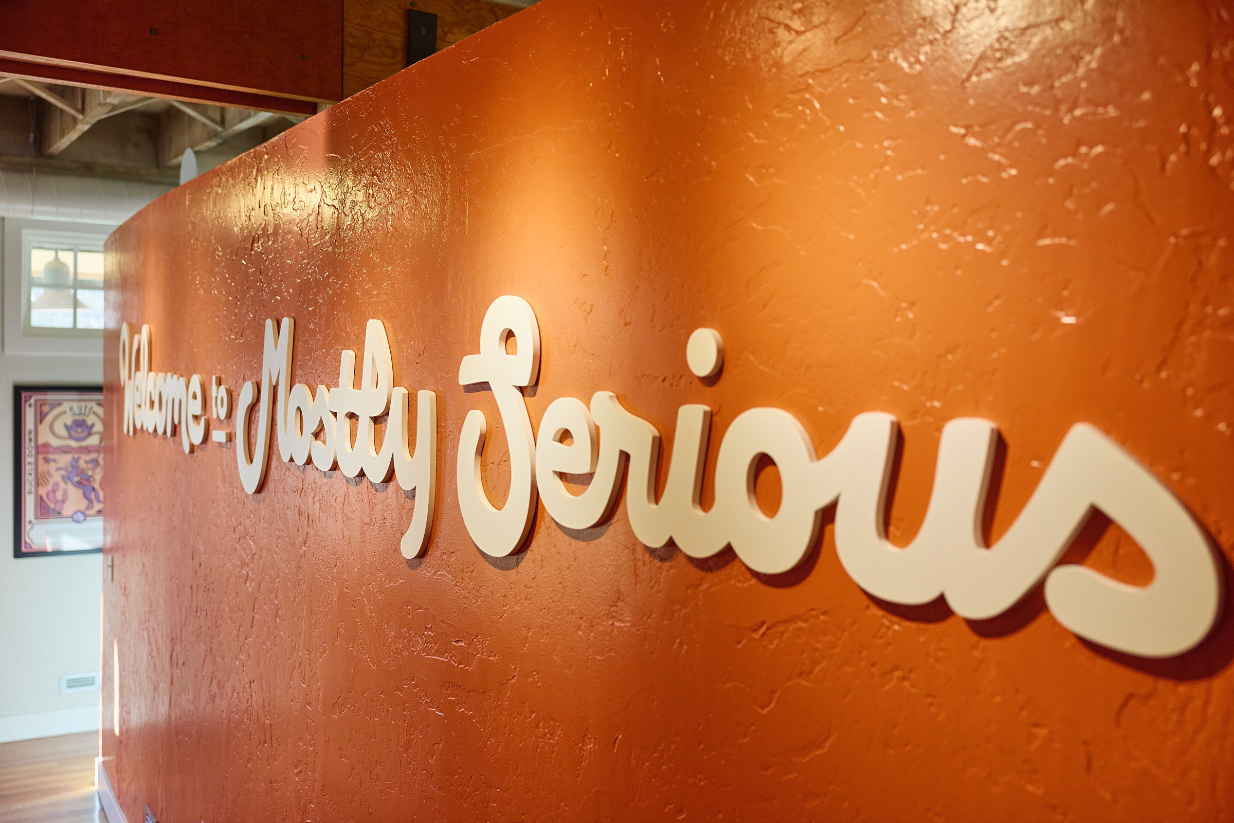 Mostly Serious office workspace with team members collaborating