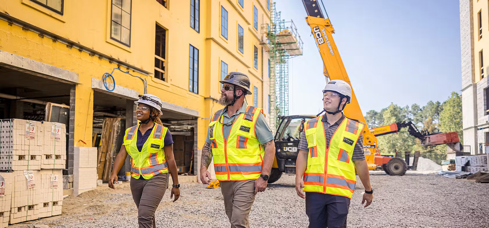 Three Choate construction professionals walking together on a project site.