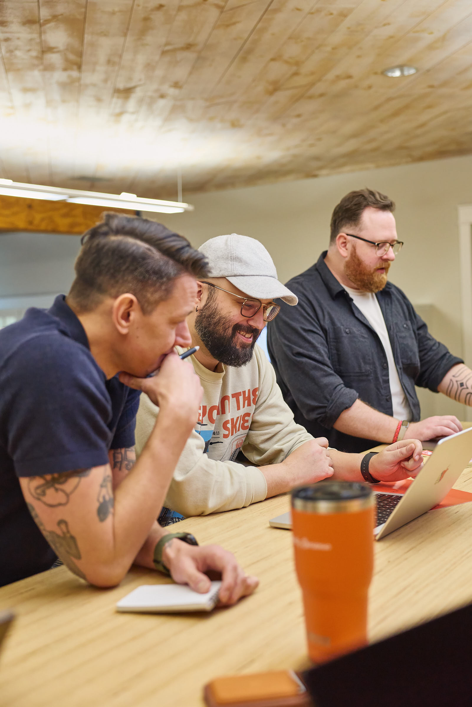 Mostly Serious team members collaborating at a standing table