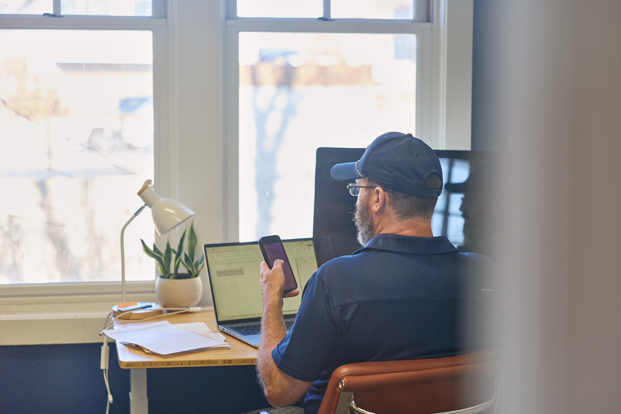 A Mostly Serious team member handling support at his desk.